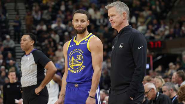 Golden State Warriors guard Stephen Curry (30) and head coach Steve Kerr talk on the sideline during the first quarter against the Utah Jazz at Delta Center. Mandatory Credit: Chris Nicoll-Imagn Images
