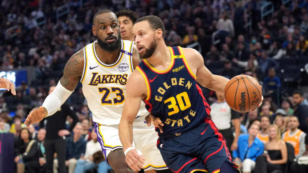 Golden State Warriors guard Stephen Curry (30) dribbles against Los Angeles Lakers forward LeBron James (23) during the third quarter at Chase Center. Mandatory Credit: Darren Yamashita-Imagn Images