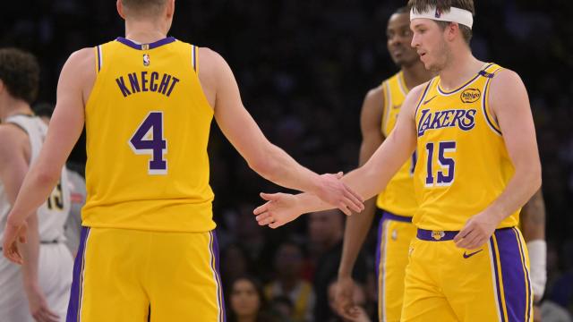 Los Angeles, California, USA; Los Angeles Lakers guard Dalton Knecht (4) and guard Austin Reaves (15) on the court in the first half against the Denver Nuggets at Crypto.com Arena. Mandatory Credit: Jayne Kamin-Oncea-Imagn Images
