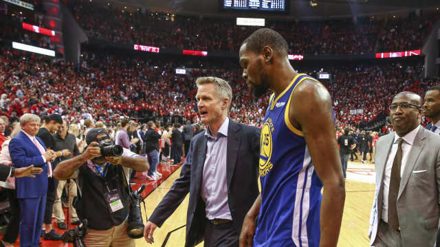 May 6, 2019; Houston, TX, USA; Golden State Warriors head coach Steve Kerr (center) and forward Kevin Durant (35) walk off the court after game four of the second round of the 2019 NBA Playoffs against the Houston Rockets at Toyota Center. Mandatory Credit: Troy Taormina-Imagn Images