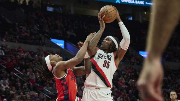 Portland Trail Blazers center Robert Williams III (35) grabs a rebound during the second half against LA Clippers guard Terance Mann (14) at Moda Center. Mandatory Credit: Troy Wayrynen-Imagn Images