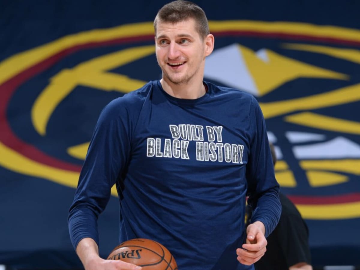 Nikola Jokic clowning around with kids at a camp who wanted him to