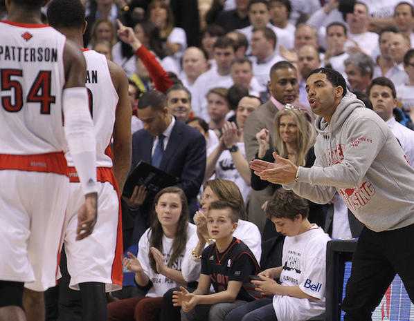 TORONTO, ON - APRIL 22: Rap star Drake cheers as the Toronto Raptors take on the Brooklyn Nets in Game Two of the NBA Eastern Conference Quarterfinals at the Air Canada Centre on April 22, 2014 in Toronto, Ontario, Canada. The Raptors defeated the Nets 100-95 to even the series 1-1. NOTE TO USER: user expressly acknowledges and agrees that, by downloading and/or using this Photograph, user is consenting to the terms and conditions of the Getty Images License Agreement. (Photo by Claus Andersen/Getty Images)