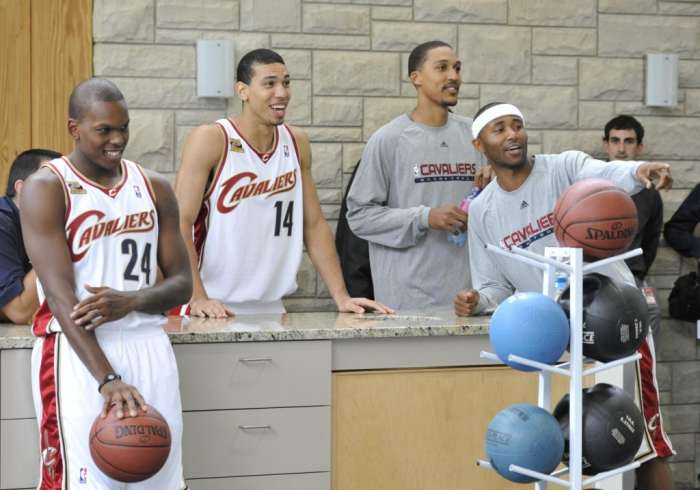 Cleveland Cavaliers Russell Robinson, left, Danny Green, Jamario Moon and Mo Williams are entertained as they watch the throng of reporters covering Shaquille O'Neil after the power outage during media day on Monday at the Cleveland Clinic Courts in Independence. MORNING JOURNAL/NATE PARSONS