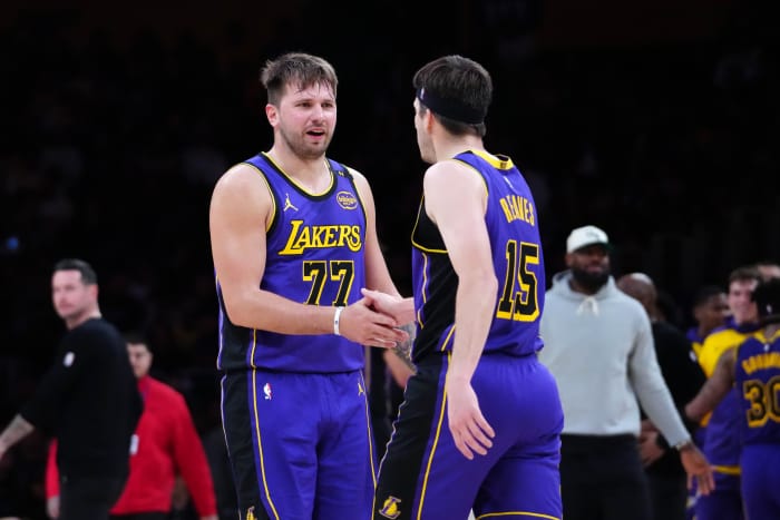 Los Angeles Lakers guard Luka Doncic (77) and guard Austin Reaves (15) react against the San Antonio Spurs in the first half at Crypto.com Arena. Mandatory Credit: Kirby Lee-Imagn Images