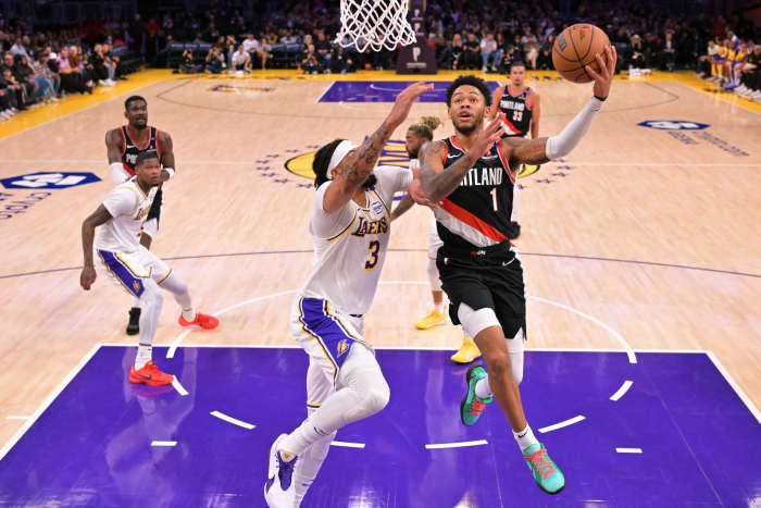 Dec 8, 2024; Los Angeles, California, USA; Los Angeles Lakers forward Anthony Davis (3) defends a shot by Portland Trail Blazers guard Anfernee Simons (1) in the first half at Crypto.com Arena. Mandatory Credit: Jayne Kamin-Oncea-Imagn Images  