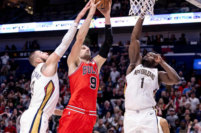  Chicago Bulls center Nikola Vucevic (9) drives to the basket against New Orleans Pelicans forward Zion Williamson (1) and center Jonas Valanciunas (17) during the second half at Smoothie King Center. Mandatory Credit: Stephen Lew-Imagn Images