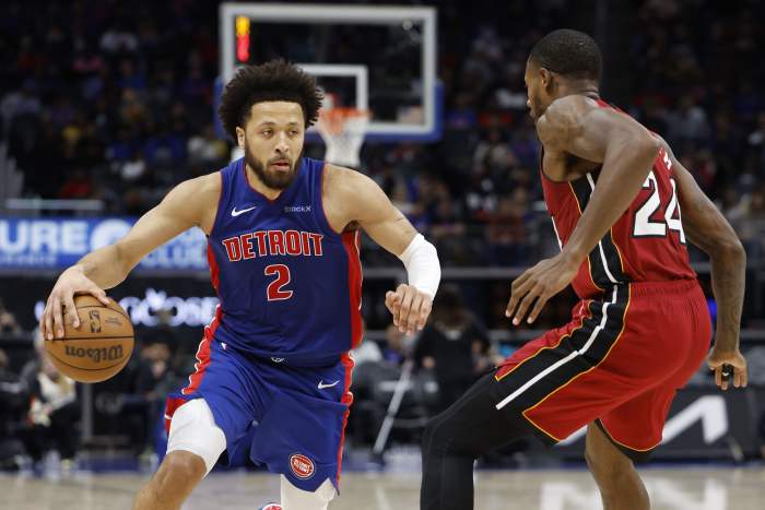 Dec 16, 2024; Detroit, Michigan, USA; Detroit Pistons guard Cade Cunningham (2) dribbles as Miami Heat forward Haywood Highsmith (24) defends in the second half at Little Caesars Arena. Mandatory Credit: Rick Osentoski-Imagn Images