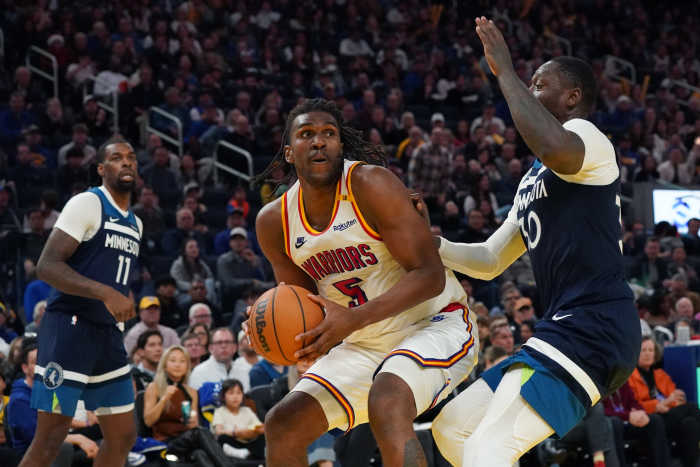 Dec 8, 2024; San Francisco, California, USA; Golden State Warriors forward Kevon Looney (5) drives to the basket against Minnesota Timberwolves forward-center Julius Randle (30) in the fourth period at Chase Center. Mandatory Credit: David Gonzales-Imagn Images