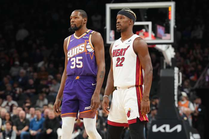 Phoenix Suns forward Kevin Durant (35) and Miami Heat forward Jimmy Butler (22) look on during the first half at Footprint Center.