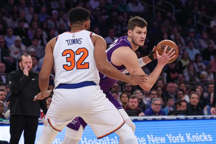 Jan 1, 2025; New York, New York, USA; Utah Jazz center Walker Kessler (24) shields the ball from New York Knicks center Karl-Anthony Towns (32) during the first half at Madison Square Garden. Mandatory Credit- Vincent Carchietta-Imagn Images