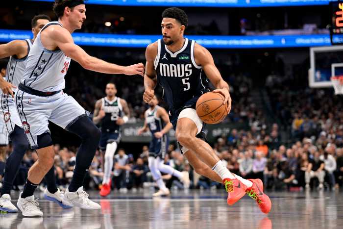 Jan 27, 2025; Dallas, Texas, USA; Dallas Mavericks guard Quentin Grimes (5) drives to the basket against Washington Wizards forward Corey Kispert (24) during the second quarter at the American Airlines Center. Mandatory Credit: Jerome Miron-Imagn Images