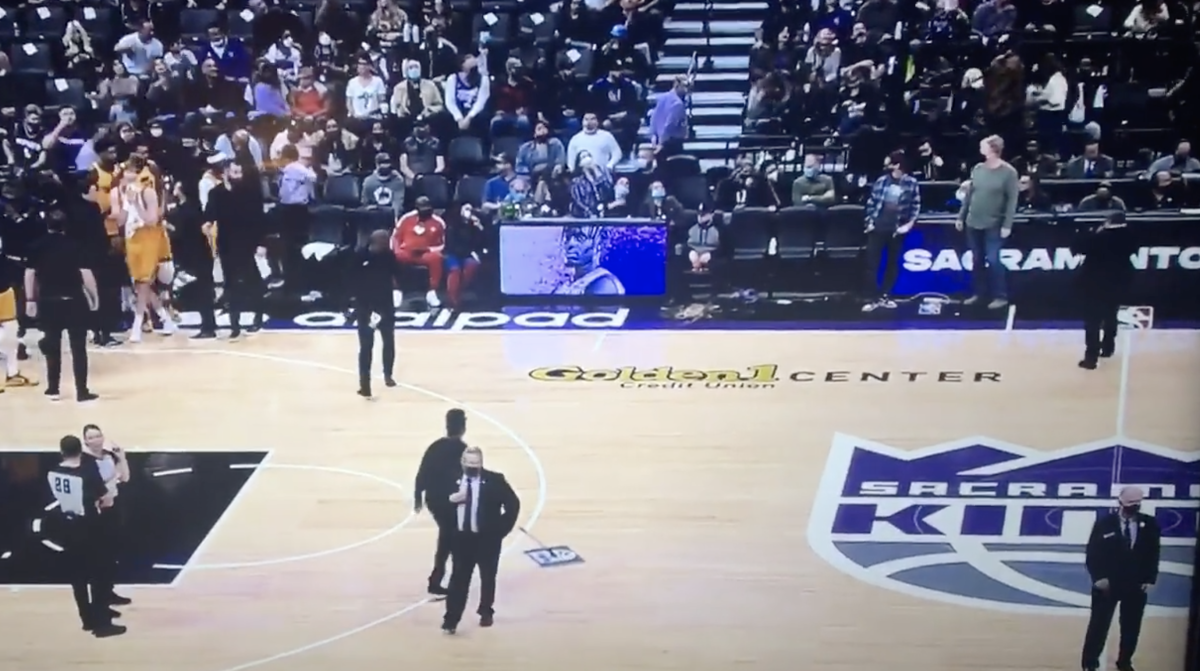 Drunk Courtside Fan Causes Awkward Delay After Puking During Game