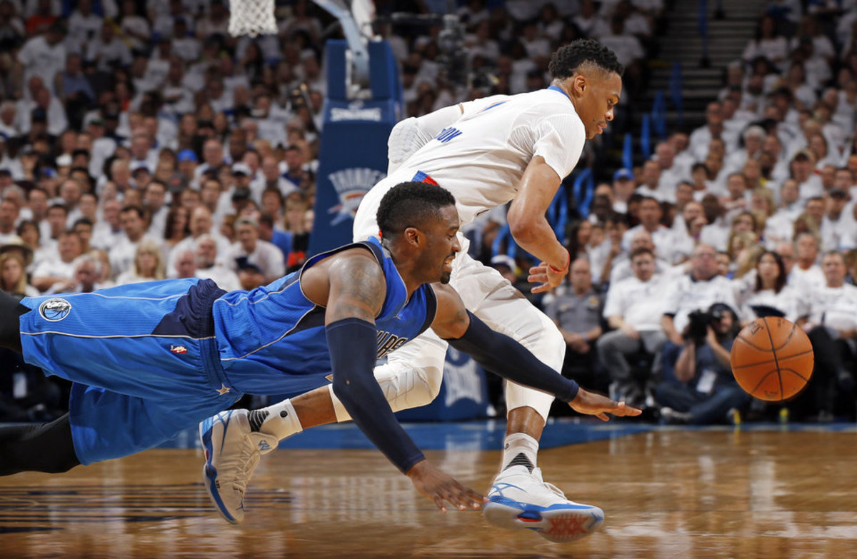 Dallas' Wesley Matthews (23) and Oklahoma City's Russell Westbrook (0) chase the ball during Game 2 of the first round series between the Oklahoma City Thunder and the Dallas Mavericks in the NBA playoffs at Chesapeake Energy Arena in Oklahoma City, Monday, April 18, 2016. Dallas won 85-84. Photo by Nate Billings, The Oklahoman