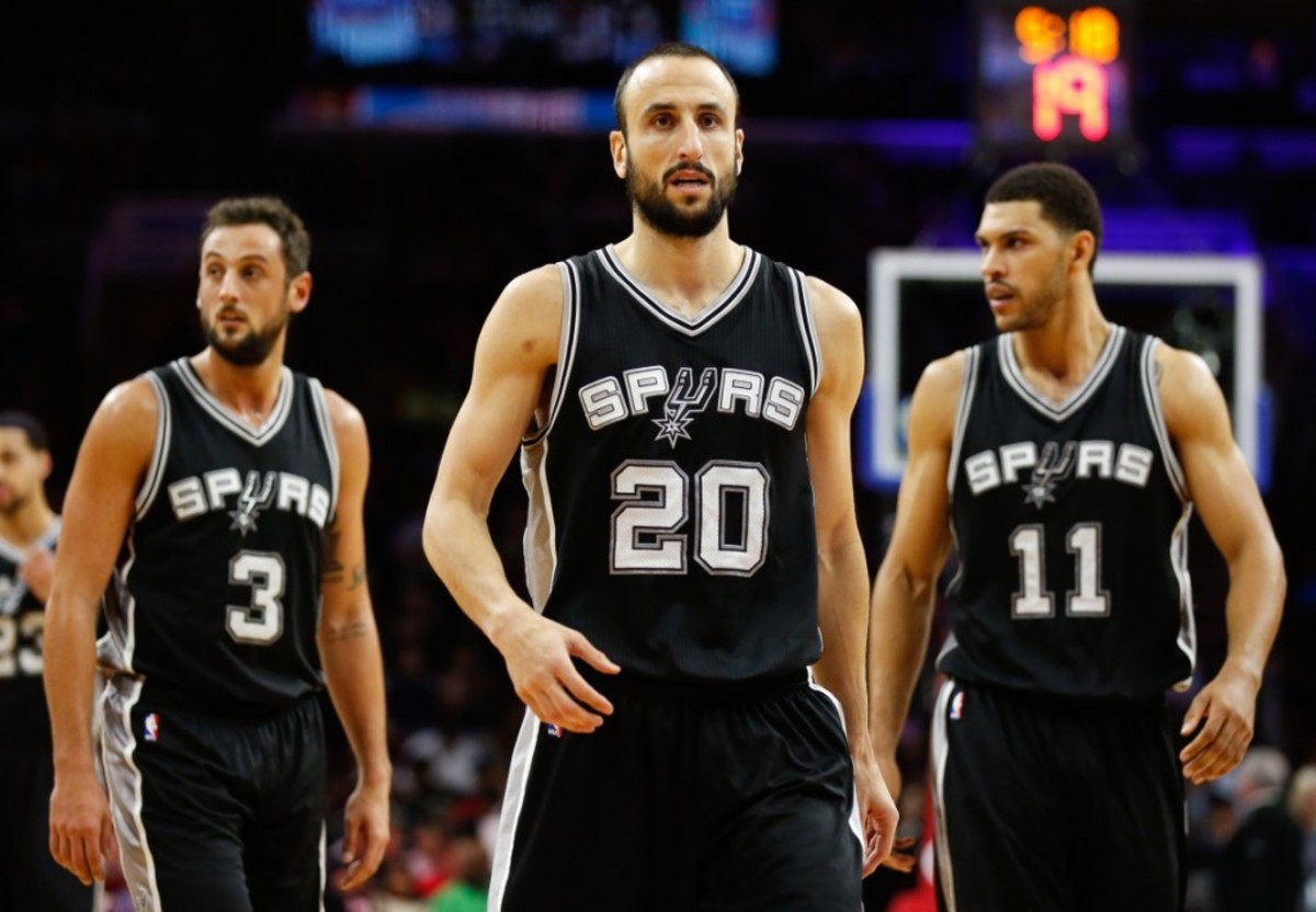 Dec 1, 2014; Philadelphia, PA, USA; San Antonio Spurs guard Manu Ginobili (20) and guard Marco Belinelli (3) and forward Jeff Ayres (11) walk across the court during the second half of a game against the Philadelphia 76ers at Wells Fargo Center. The Spurs defeated the 76ers 109-103. Mandatory Credit: Bill Streicher-USA TODAY Sports