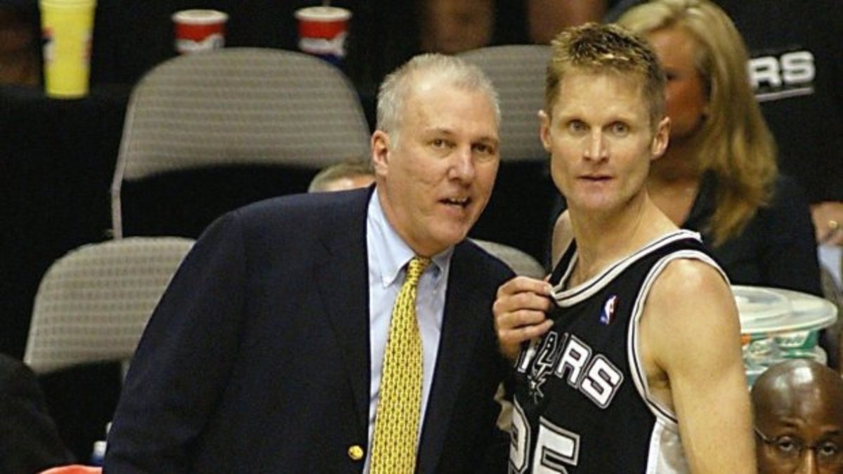 Head coach Gregg Popovich, left, and Steve Kerr of the San Antonio Spurs celebrates after game six of the NBA Western Conference Finals on May 29, 2003, at the American Airlines Center in Dallas, Texas.  Kerr made four of four three-point baskets to lead the Spurs. The Spurs won the game 90-78 to win the best-of-seven game series 4-2 to defeat the Dallas Mavericks. (James Nielsen/AFP/Getty Images)