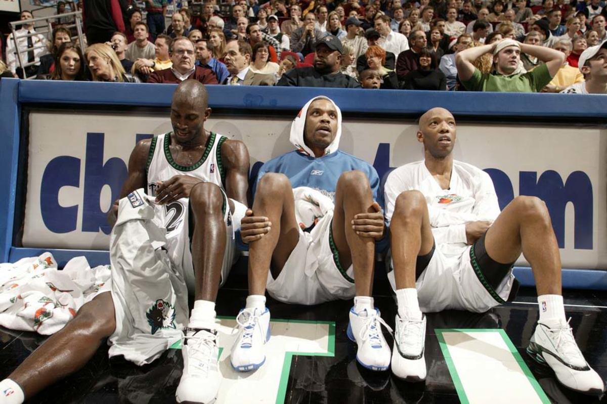MINNEAPOLIS - DECEMBER 16:  (L-R) Kevin Garnett #21, Latrell Sprewell #8 and Sam Cassell #19 of the Minnesota Timberwolves relax on the sideline during the final minutes of a blowout victory, 92-75 over the Houston Rockets on December 16, 2003 at Target Center in Minneapolis, Minnesota.  NOTICE TO USER: User expressly acknowledges and agrees that, by downloading and/or using this Photograph, user is consenting to the terms and conditions of the Getty Images License Agreement.  (Photo By David Sherman/NBAE via Getty Images)