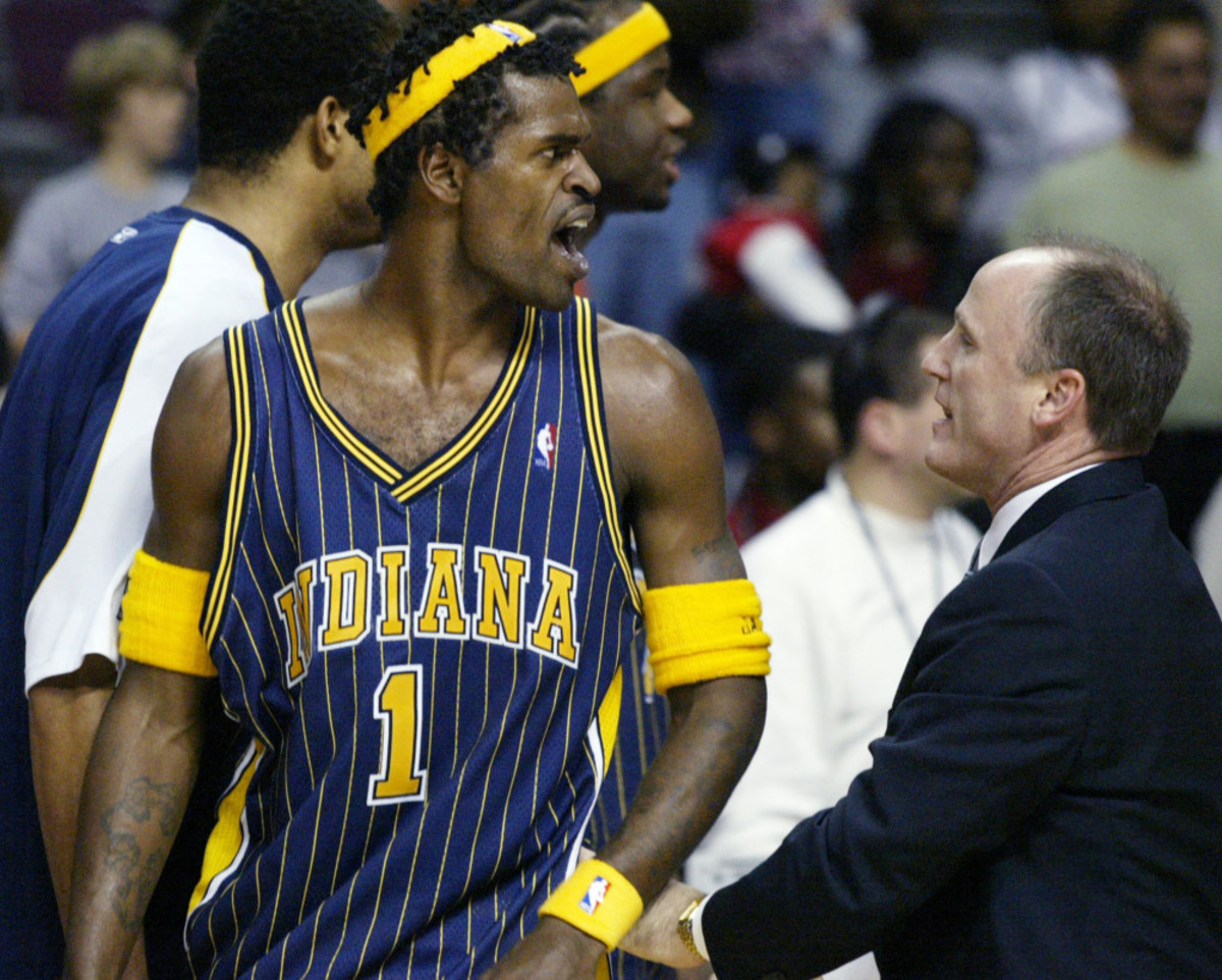 Indiana Pacers' Stephen Jackson (1) is escorted off the court by  following their fight with the Detroit Pistons and fans Friday, Nov. 19, 2004, in Auburn Hills, Mich. (AP Photo/Duane Burleson) ORG XMIT: DCB105