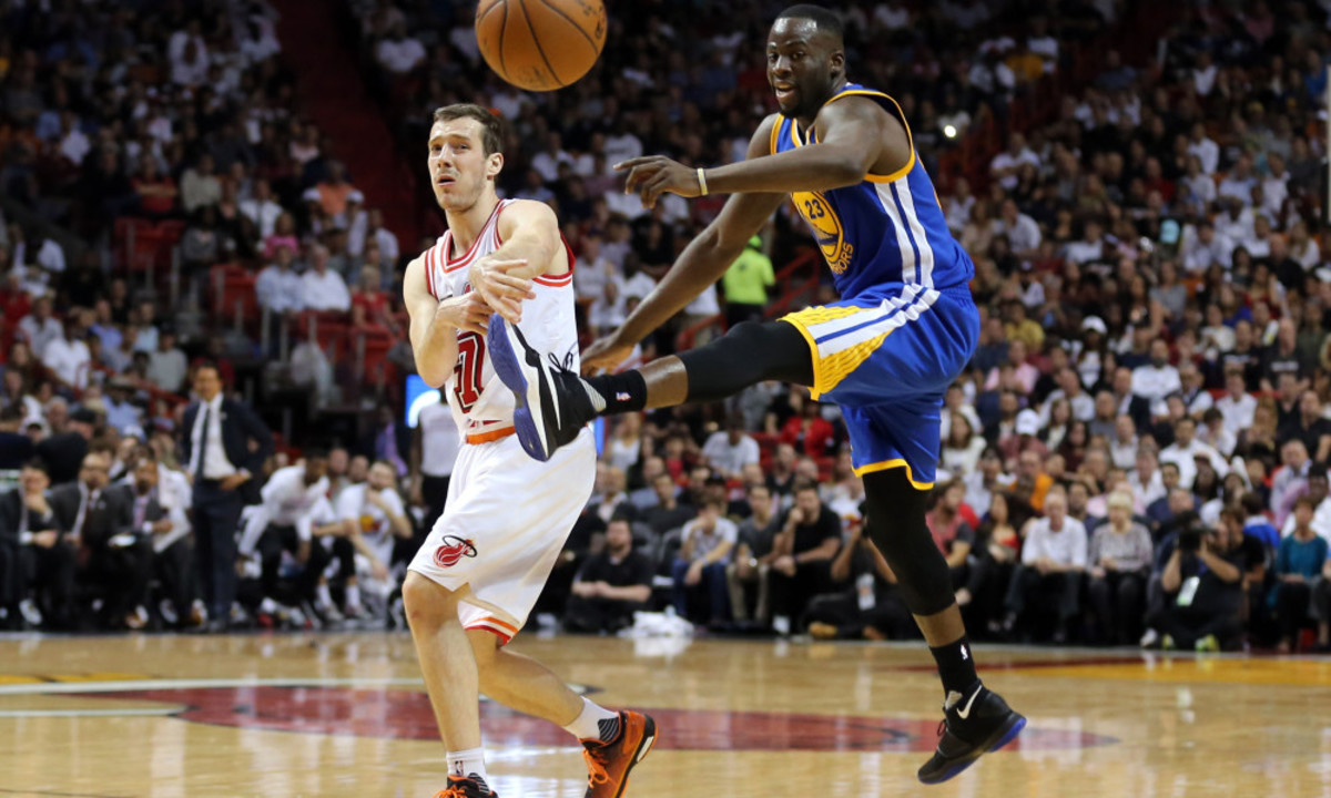 Feb 24, 2016; Miami, FL, USA; Miami Heat guard Goran Dragic (7) passes the ball as Golden State Warriors forward Draymond Green (23) attempts to kick the ball during the second half at American Airlines Arena. Mandatory Credit: Steve Mitchell-USA TODAY Sports