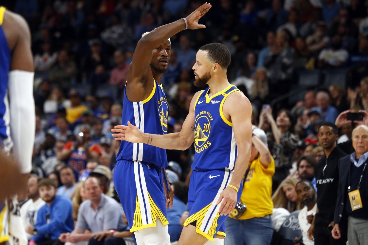 Golden State Warriors forward Jimmy Butler III (10) reacts with guard Stephen Curry (30) during the fourth quarter against the Memphis Grizzlies at FedExForum. Mandatory Credit: Petre Thomas-Imagn Images