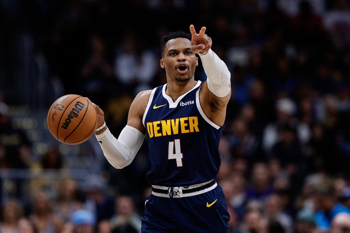 Denver Nuggets guard Russell Westbrook (4) gestures as he dribbles the ball up court in the third quarter against the San Antonio Spurs at Ball Arena.
