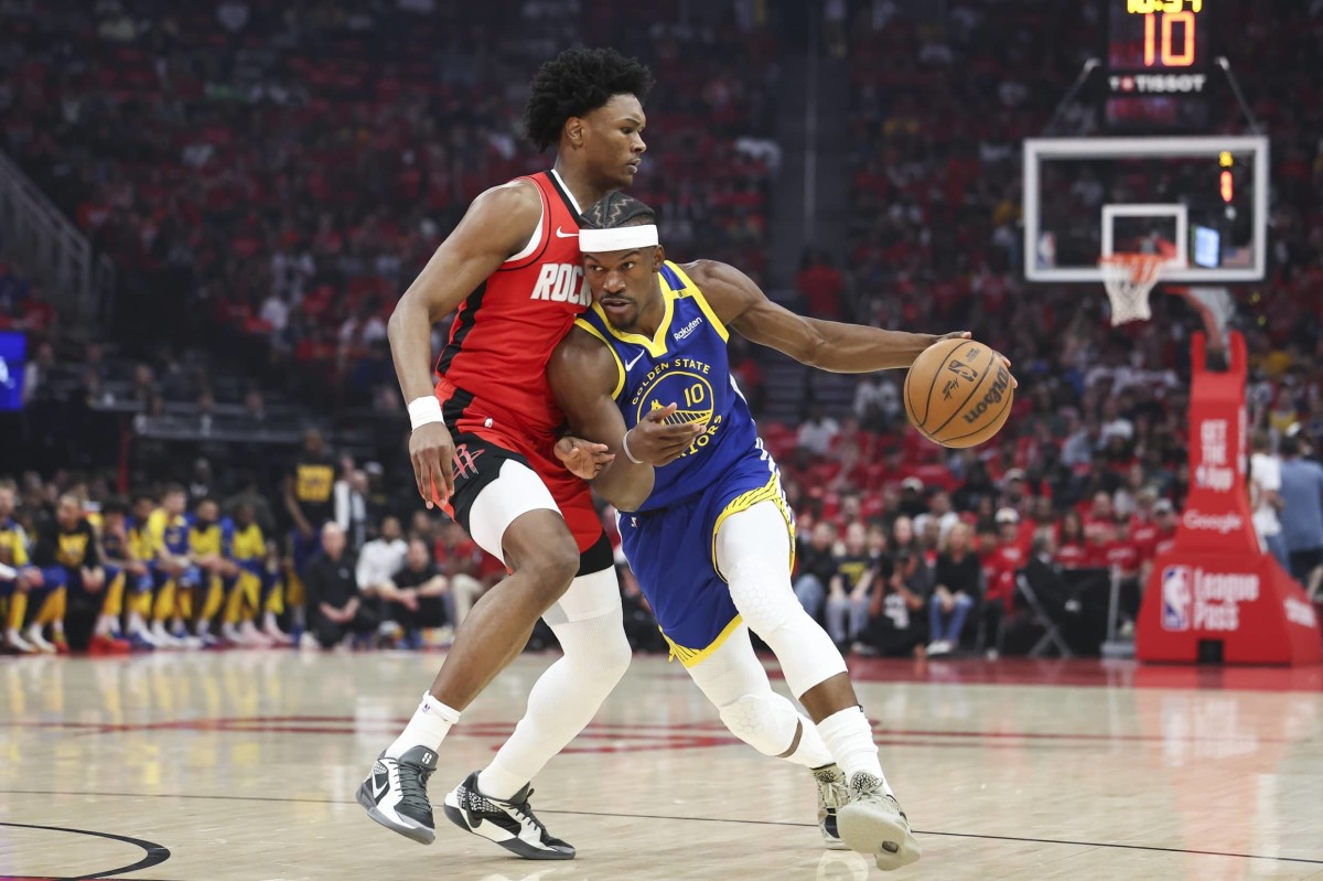 Apr 20, 2025; Houston, Texas, USA; Golden State Warriors forward Jimmy Butler III (10) dribbles the ball as Houston Rockets forward Amen Thompson (1) defends during the first quarter at Toyota Center. Mandatory Credit: Troy Taormina-Imagn Images