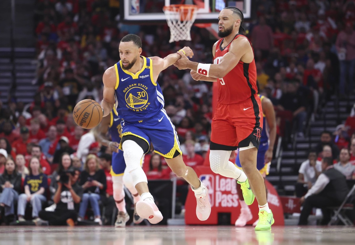 Golden State Warriors guard Stephen Curry (30) controls the ball as Houston Rockets forward Dillon Brooks (9) defends during the second quarter at Toyota Center.