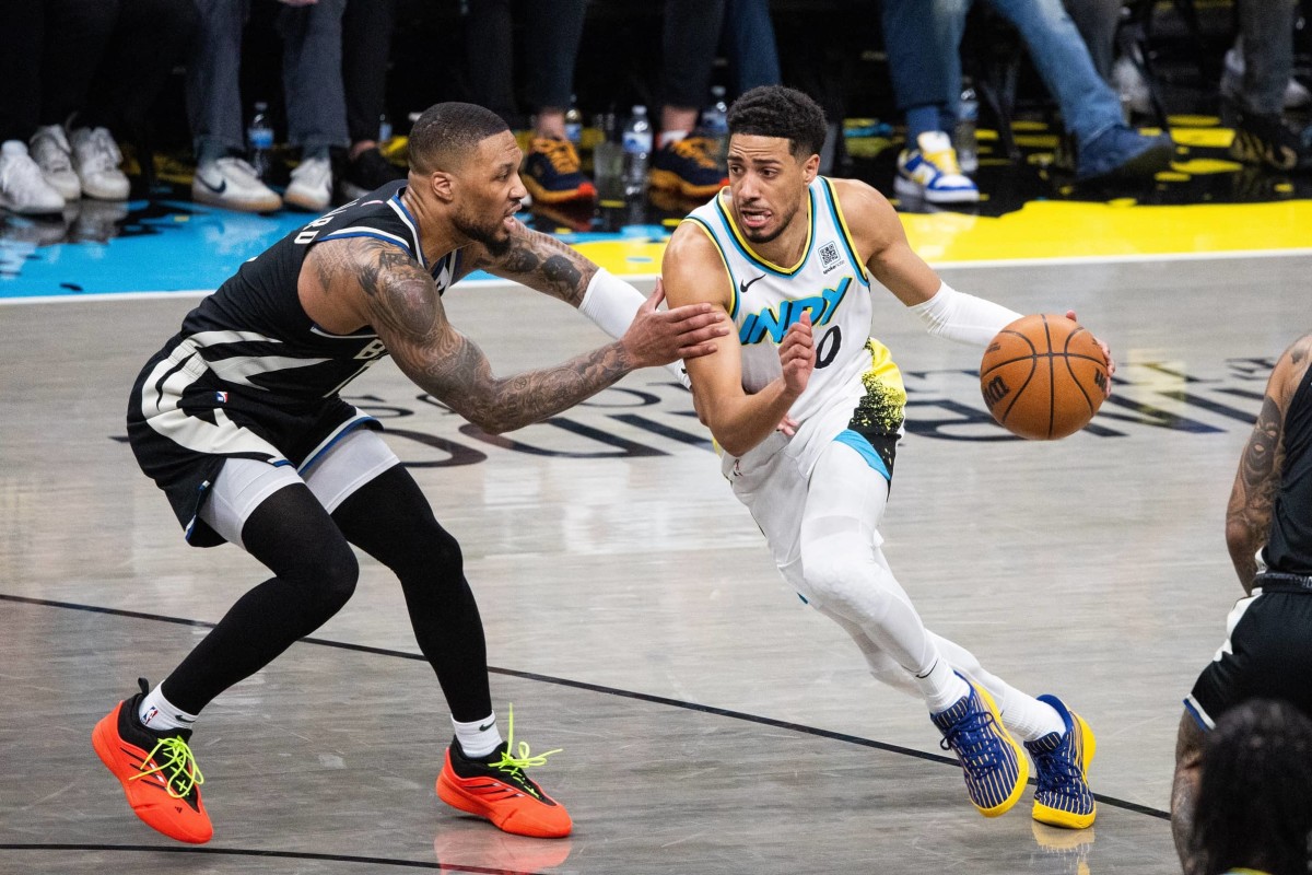 Indianapolis, Indiana, USA; Indiana Pacers guard Tyrese Haliburton (0) dribbles the ball while Milwaukee Bucks guard Damian Lillard (0) defends during game two of first round for the 2024 NBA Playoffs at Gainbridge Fieldhouse. Mandatory Credit: Trevor Ruszkowski-Imagn Images
