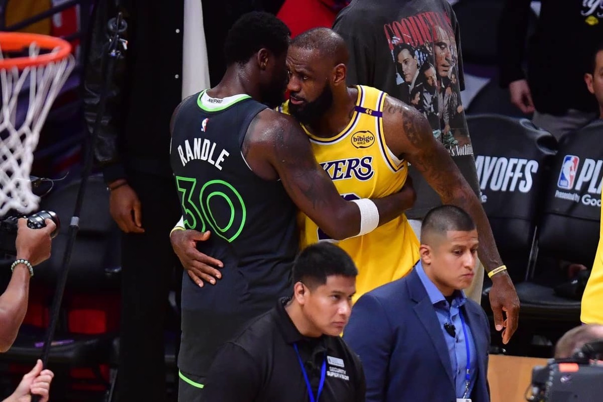 Apr 30, 2025; Los Angeles, California, USA; Minnesota Timberwolves forward Julius Randle (30) meets with Los Angeles Lakers forward LeBron James (23) following game five of first round for the 2025 NBA Playoffs at Crypto.com Arena. Mandatory Credit: Gary A. Vasquez-Imagn Images