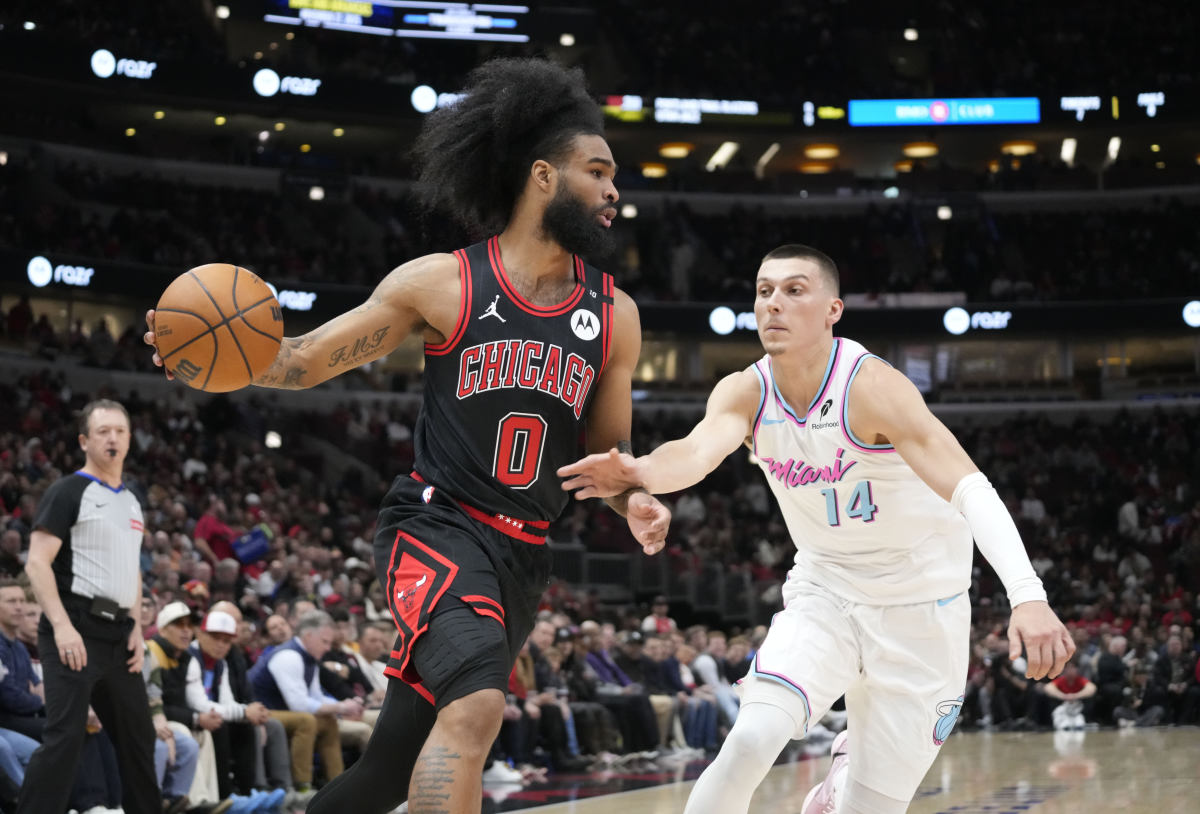 Apr 9, 2025; Chicago, Illinois, USA; Miami Heat guard Tyler Herro (14) defends Chicago Bulls guard Coby White (0) during the first quarter at United Center. Mandatory Credit: David Banks-Imagn Images