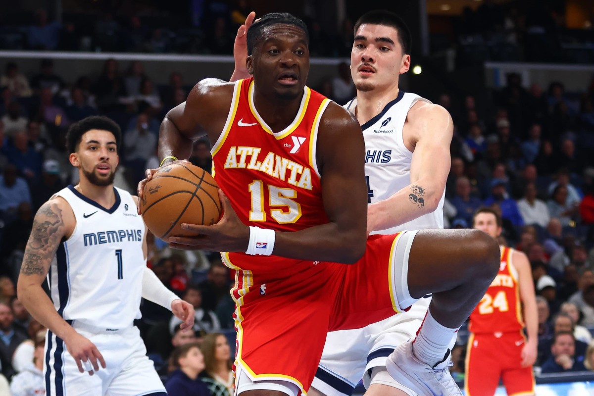 Mar 3, 2025; Memphis, Tennessee, USA; Atlanta Hawks center Clint Capela (15) collects a pass as Memphis Grizzlies center Zach Edey (14) defends during the second quarter at FedExForum. Mandatory Credit: Petre Thomas-Imagn Images