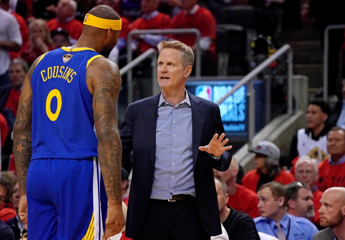 Toronto, Ontario, CAN; Golden State Warriors head coach Steve Kerr talks with center DeMarcus Cousins (0) during the second quarter against the Toronto Raptors in game five of the 2019 NBA Finals at Scotiabank Arena. Mandatory Credit: Kyle Terada-Imagn Images
