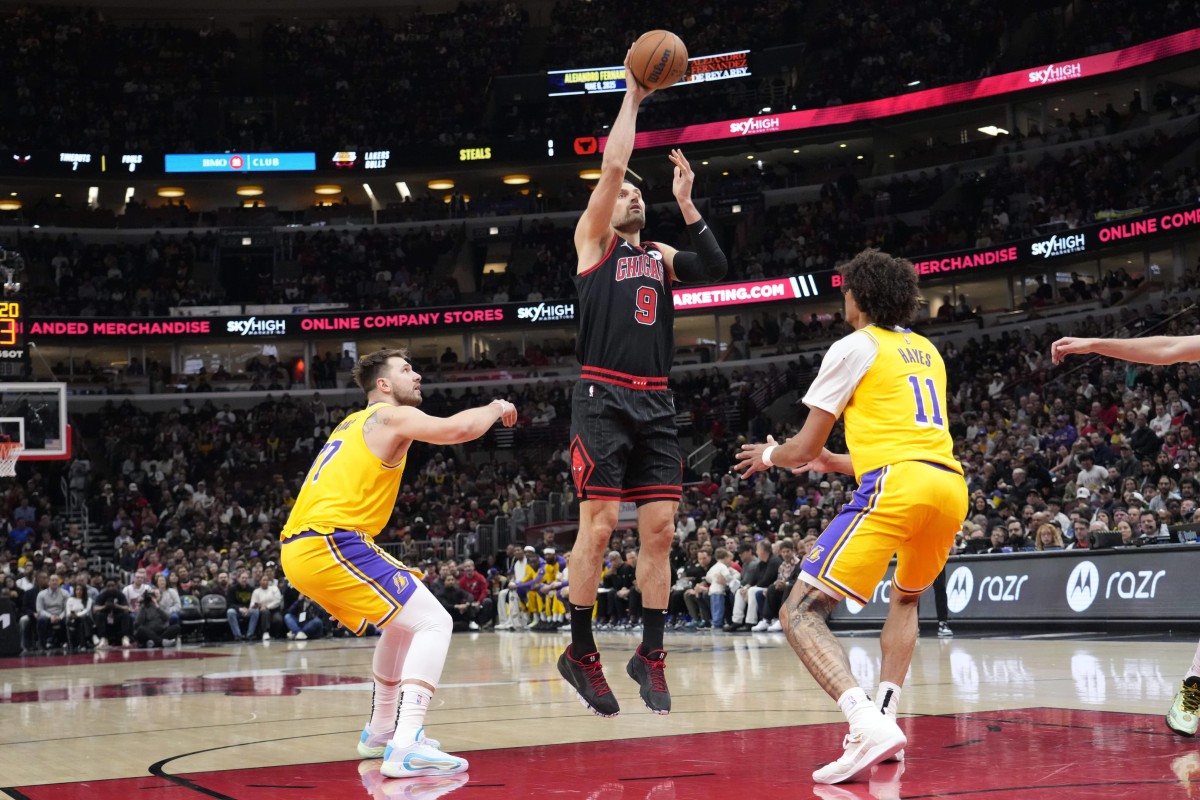 Mar 27, 2025; Chicago, Illinois, USA; Chicago Bulls center Nikola Vucevic (9) shoots over Los Angeles Lakers center Jaxson Hayes (11) during the first quarter at United Center.