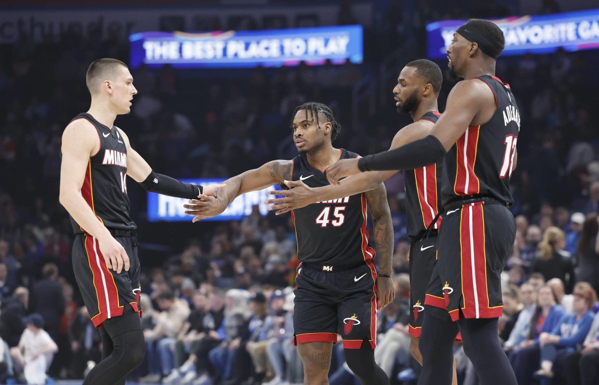 Feb 12, 2025; Oklahoma City, Oklahoma, USA; Miami Heat guard Tyler Herro (14), guard Davion Mitchell (45), forward Andrew Wiggins (22) and center Bam Adebayo (13) high five after a play against the Oklahoma City Thunder during the first quarter at Paycom Center. Mandatory Credit: Alonzo Adams-Imagn Images