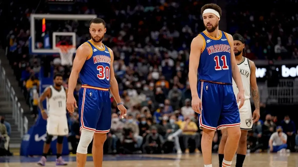 Jan 29, 2022; San Francisco, California, USA; Golden State Warriors guard Stephen Curry (30) and guard Klay Thompson (11) stand on the court during the fourth quarter against the Brooklyn Nets at the Chase Center. Mandatory Credit: Cary Edmondson-Imagn Images