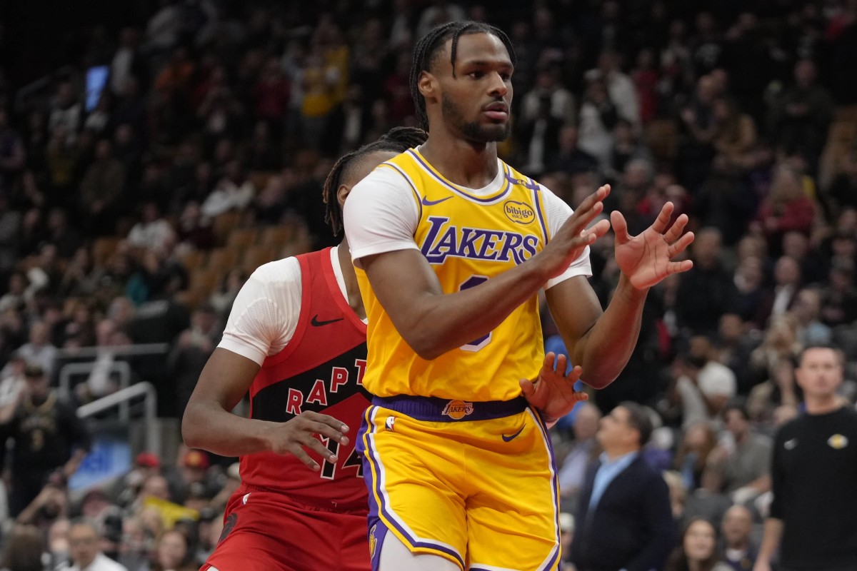 Nov 1, 2024; Toronto, Ontario, CAN; Los Angeles Lakers guard Bronny James (9) looks for a pass as Toronto Raptors guard Ja'Kobe Walter (14) defends during the second half at Scotiabank Arena.