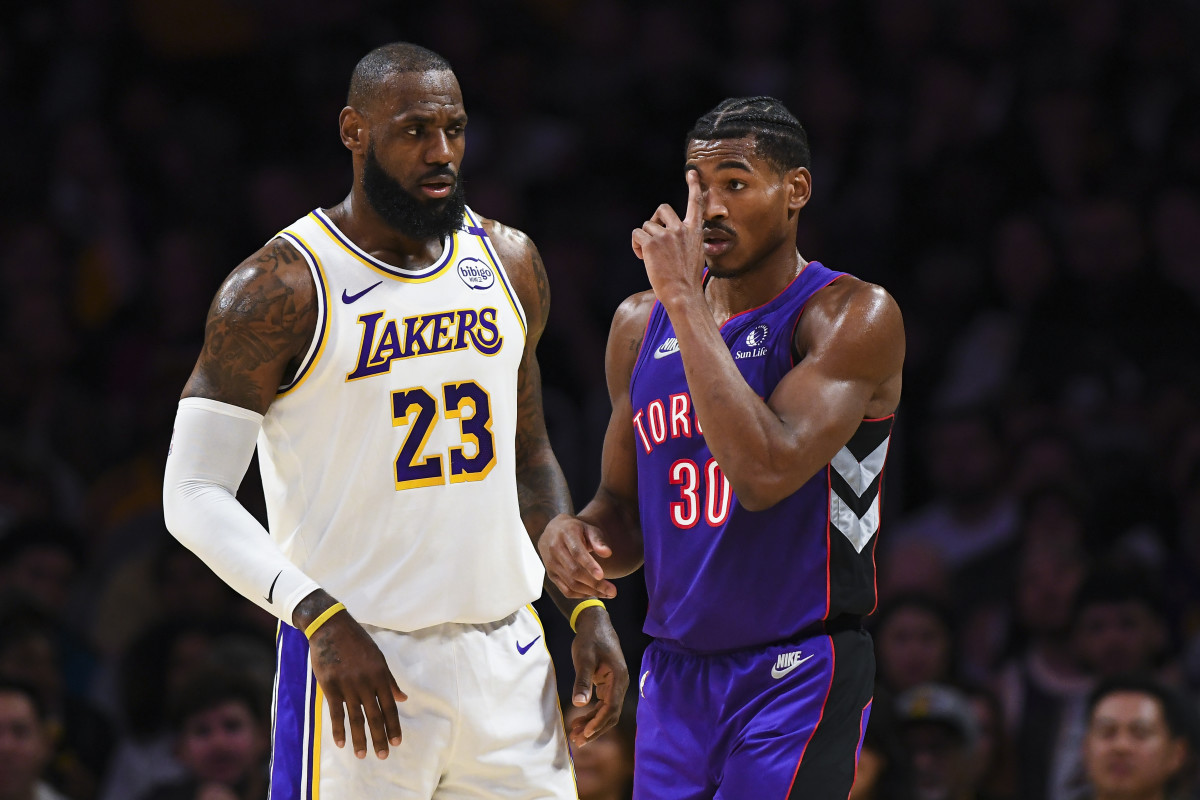 Nov 10, 2024; Los Angeles, California, USA; Los Angeles Lakers forward LeBron James (23) talks to Toronto Raptors guard Ochai Agbaji (30) during the first half at Crypto.com Arena.