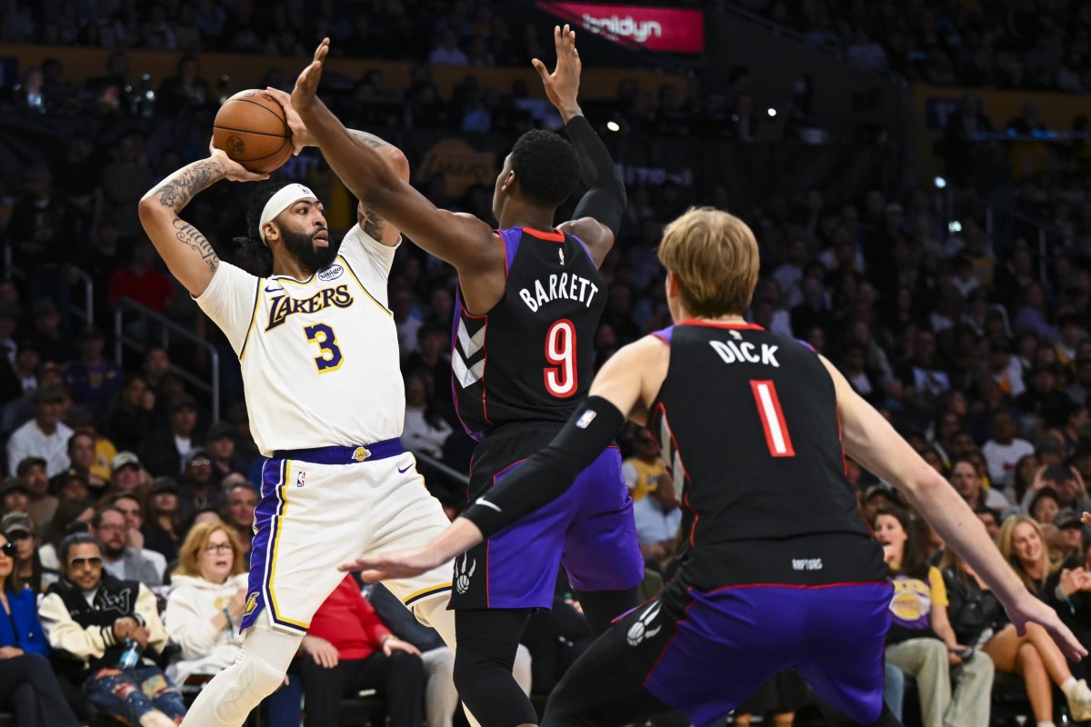 Nov 10, 2024; Los Angeles, California, USA; Los Angeles Lakers forward Anthony Davis (3) looks to pass against Toronto Raptors guard RJ Barrett (9) and guard Gradey Dick (1) during the first half at Crypto.com Arena.