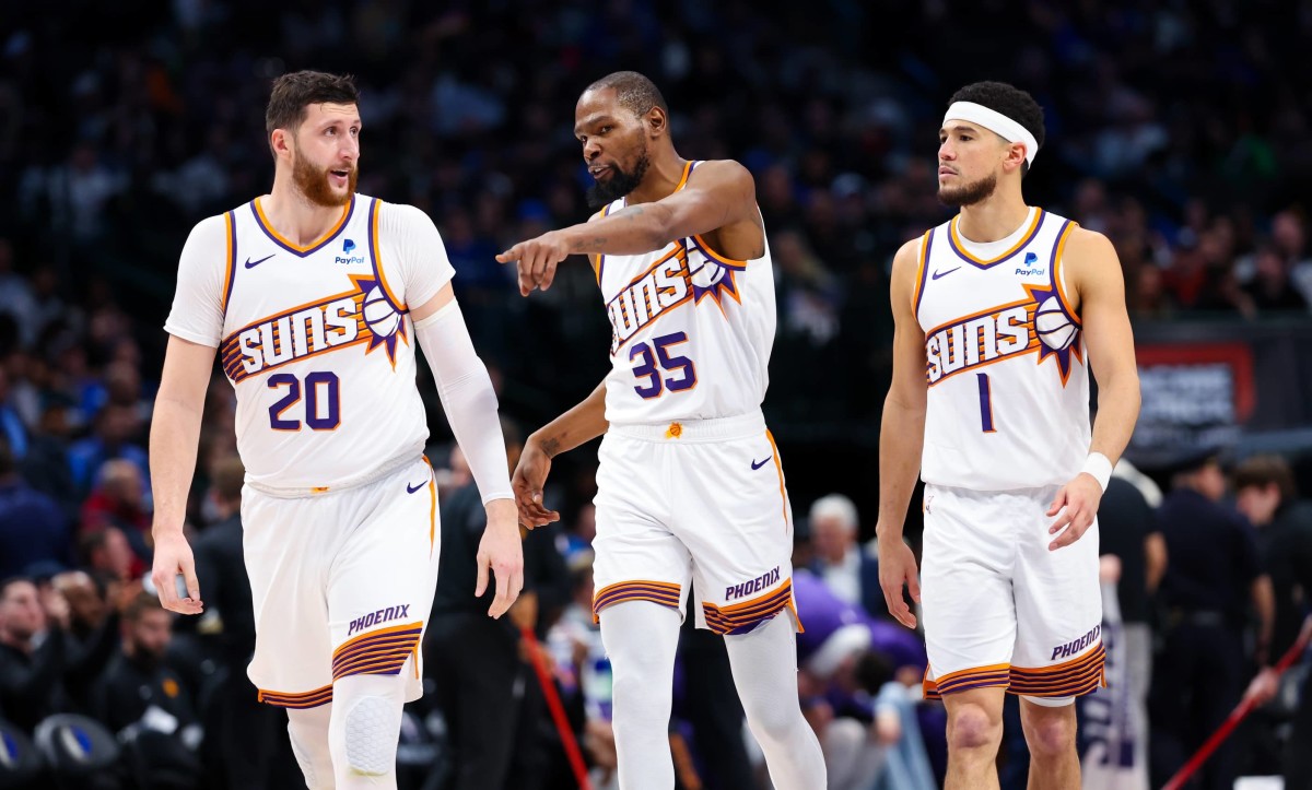 Jan 24, 2024; Dallas, Texas, USA; Phoenix Suns forward Kevin Durant (35) and Phoenix Suns guard Devin Booker (1) and Phoenix Suns center Jusuf Nurkic (20) talk during the third quarter against the Dallas Mavericks at American Airlines Center.