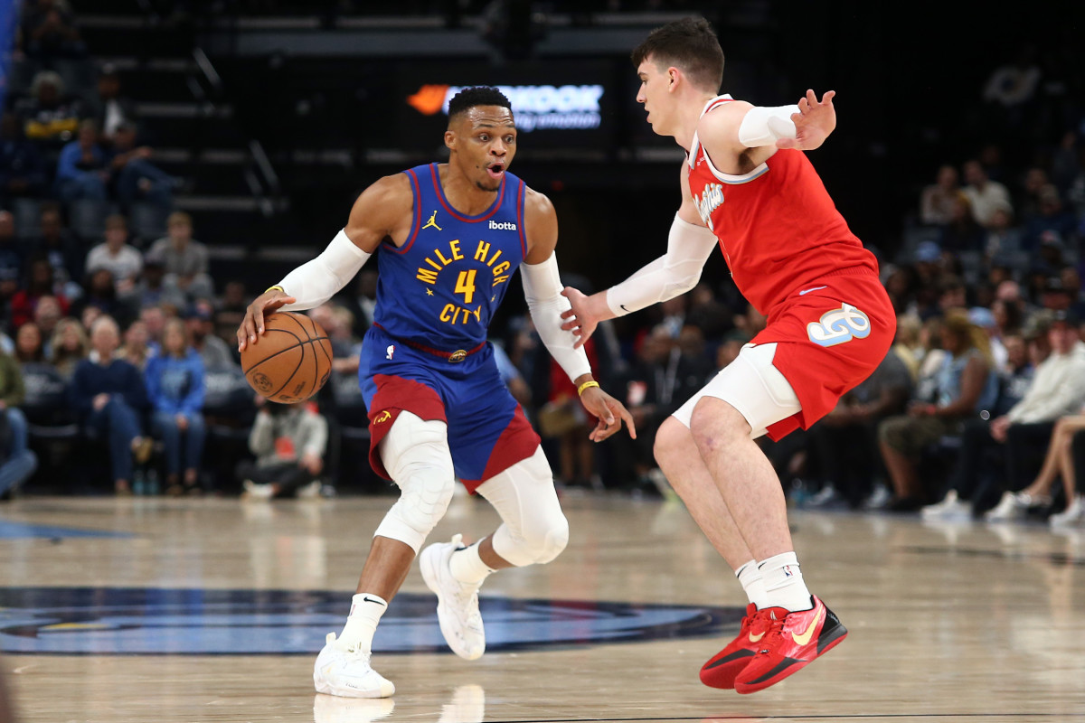 Nov 17, 2024; Memphis, Tennessee, USA; Denver Nuggets guard Russell Westbrook (4) dribbles as Memphis Grizzlies forward Jake LaRavia (3) defends during the first half at FedExForum. Mandatory Credit: Petre Thomas-Imagn Images  