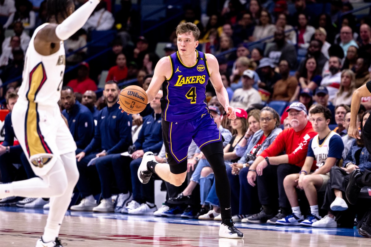 Nov 16, 2024; New Orleans, Louisiana, USA; Los Angeles Lakers guard Dalton Knecht (4) brings the ball up court against the New Orleans Pelicans during the first half at Smoothie King Center. Mandatory Credit: Stephen Lew-Imagn Images