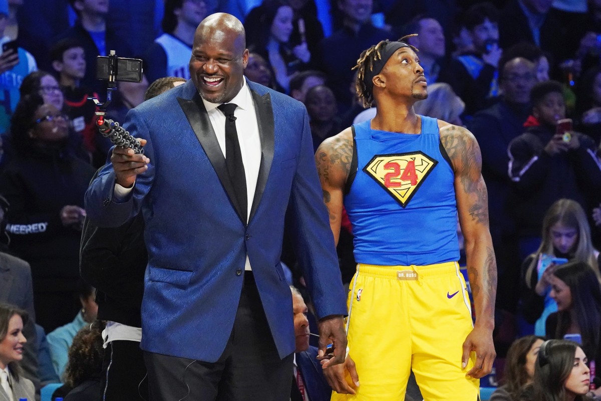Feb 15, 2020; Chicago, Illinois, USA; Former NBA player Shaquille O'Neal laughs while standing next to Los Angeles Lakers player Dwight Howard during the slam dunk contest during NBA All Star Saturday Night at United Center. Mandatory Credit: Kyle Terada-Imagn Images