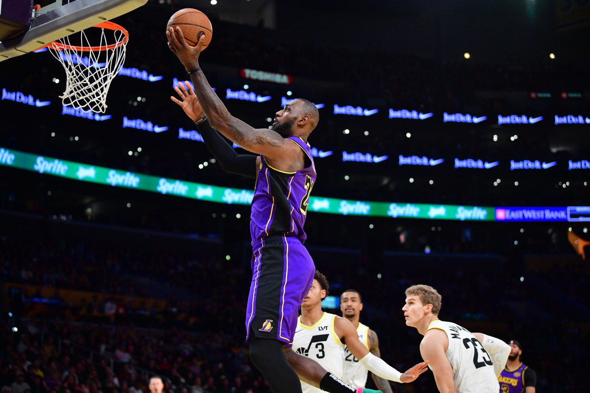 Nov 19, 2024; Los Angeles, California, USA; Los Angeles Lakers forward LeBron James (23) scores a basket against the against the Utah Jazz during the first half at Crypto.com Arena. Mandatory Credit: Gary A. Vasquez-Imagn Images