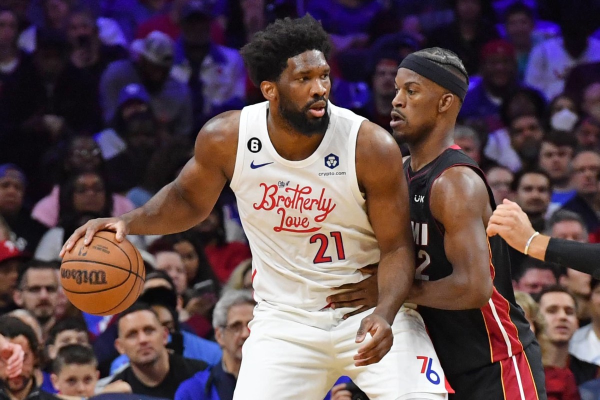 Apr 6, 2023; Philadelphia, Pennsylvania, USA; Philadelphia 76ers center Joel Embiid (21) is defended by Miami Heat forward Jimmy Butler (22) during the second quarter at Wells Fargo Center. Mandatory Credit: Eric Hartline-Imagn Images  