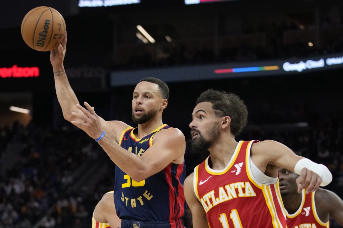 November 20, 2024; San Francisco, California, USA; Golden State Warriors guard Stephen Curry (30) passes the basketball against Atlanta Hawks guard Trae Young (11) during the third quarter at Chase Center. Mandatory Credit: Kyle Terada-Imagn Images  