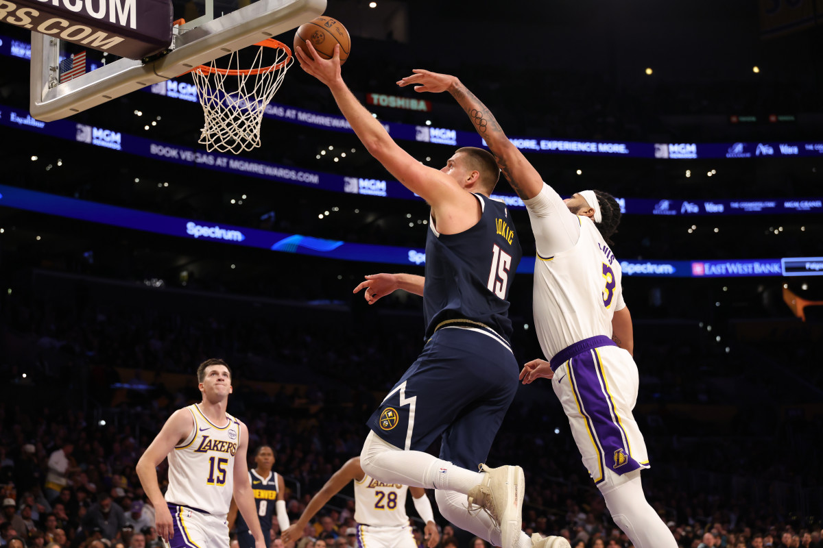 Nov 23, 2024; Los Angeles, California, USA; Denver Nuggets center Nikola Jokic (15) goes to the basket past Los Angeles Lakers forward Anthony Davis (3) during the second quarter at Crypto.com Arena. Mandatory Credit: Kiyoshi Mio-Imagn Images  