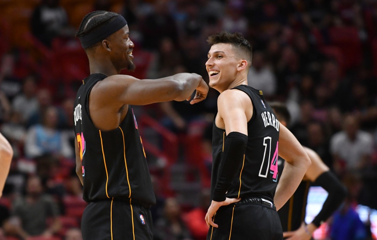 Miami Heat forward Jimmy Butler (22) and teammate guard Tyler Herro (14) share a moment after Herro was called for a technical foul during the first half against the Cleveland Cavaliers at FTX Arena. Mandatory Credit: Jim Rassol-Imagn Images