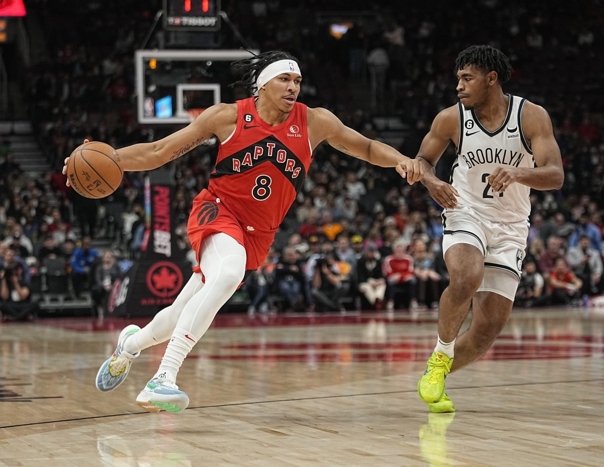 Nov 23, 2022; Toronto, Ontario, CAN; Toronto Raptors guard Ron Harper Jr. (8) drives to the net against Brooklyn Nets guard Cam Thomas (24) during the second half at Scotiabank Arena. 