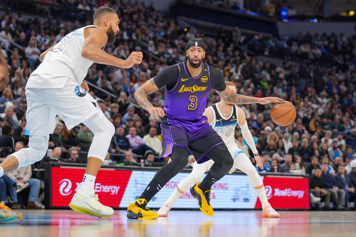 Dec 2, 2024; Minneapolis, Minnesota, USA; Los Angeles Lakers forward Anthony Davis (3) dribbles against Minnesota Timberwolves center Rudy Gobert (27) in the second quarter at Target Center. Mandatory Credit: Brad Rempel-Imagn Images  