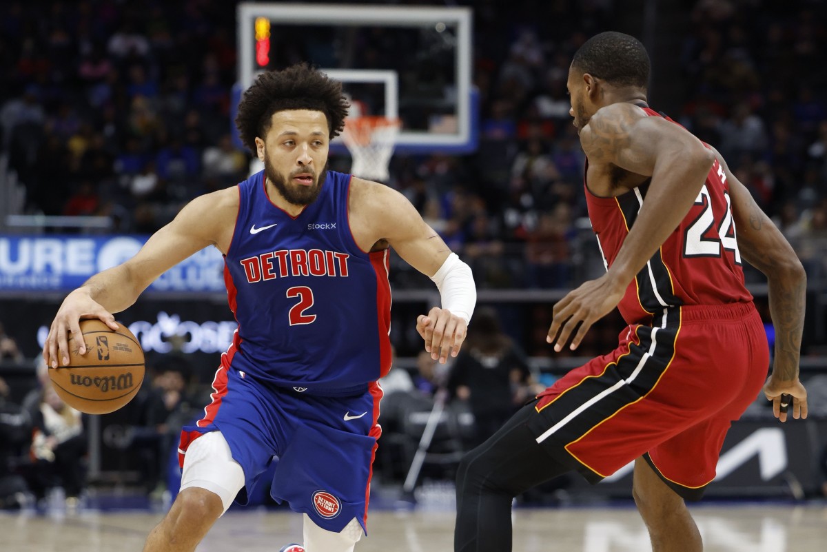 Dec 16, 2024; Detroit, Michigan, USA; Detroit Pistons guard Cade Cunningham (2) dribbles as Miami Heat forward Haywood Highsmith (24) defends in the second half at Little Caesars Arena. Mandatory Credit: Rick Osentoski-Imagn Images